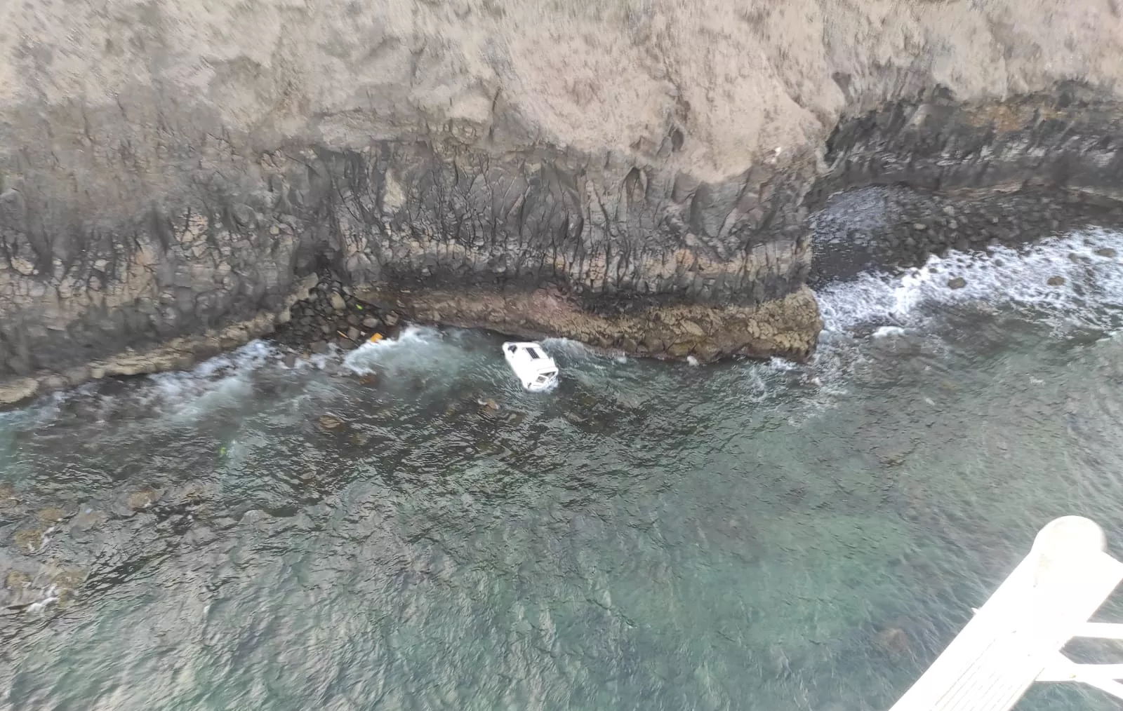 A woman is injured when her car rolls off a cliff and falls 100ft into the sea