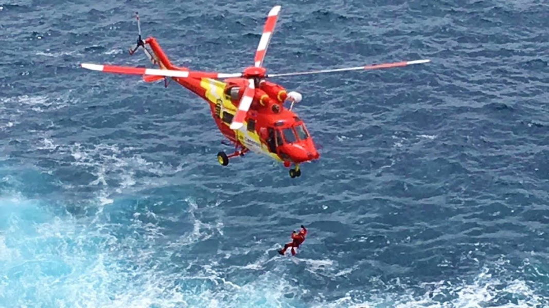 Woman rescued from sea by helicopter after breaking collar bone